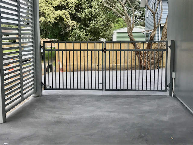 bi fold black metal bar gate manual drive way car