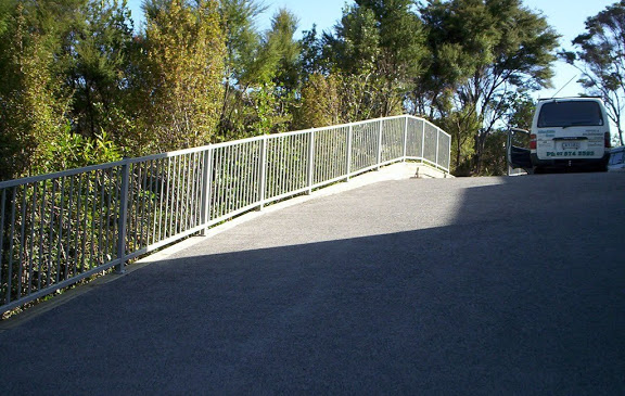 vertical metal bar fence for slopes sloping driveway